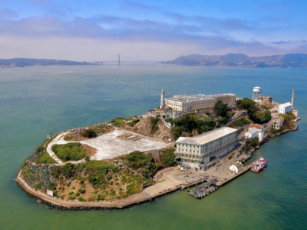 View of Alcatraz Island surrounded by blue waters in San Francisco Bay
