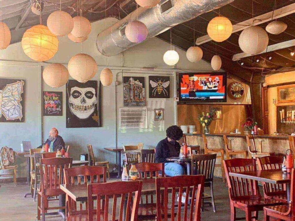 Cozy Austin coffee shop with warm lighting, wooden tables, and locals working quietly