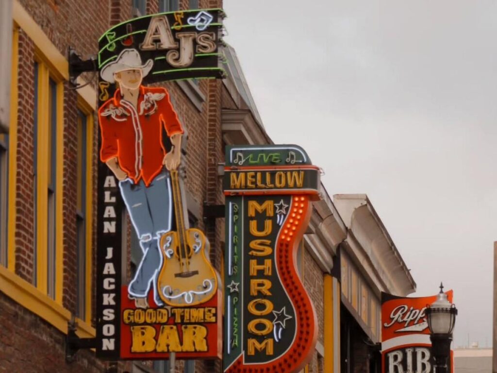 Broadway in Nashville during the day with honky tonk signs and live music venues