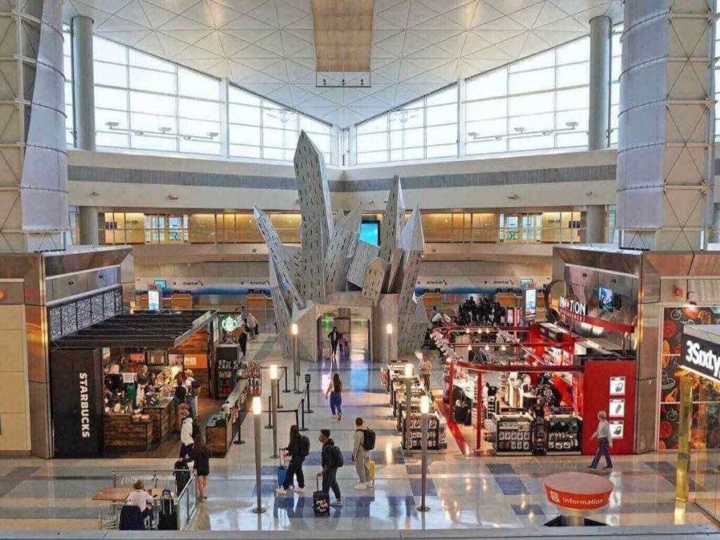 Inside Dallas–Fort Worth International Airport with passengers walking through the terminal