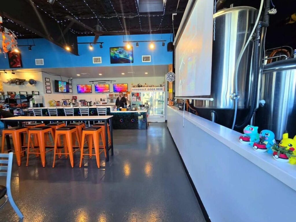 Outdoor tables at an East Austin brewery with string lights and relaxed afternoon crowds