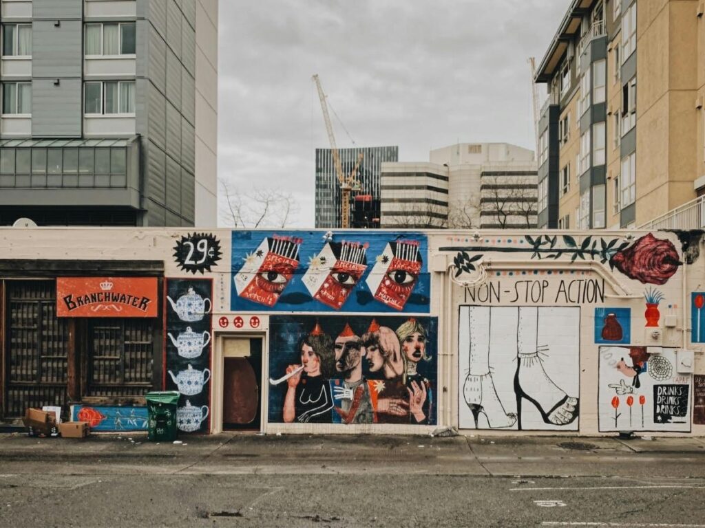 Colorful mural wall in East Austin surrounded by small shops and relaxed morning activity