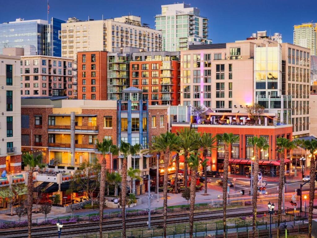 Colorful neon lights and historic buildings in San Diego’s Gaslamp Quarter at night.