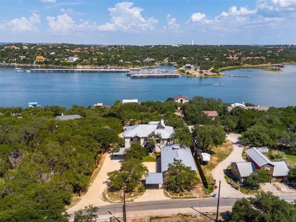 Calm sunset view over Lake Travis with boats and warm pink sky