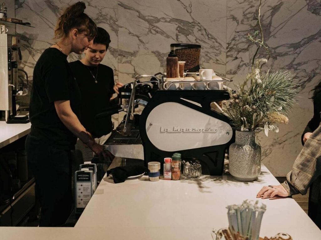 Cozy interior of Little Owl Coffee in Denver with espresso bar and seating