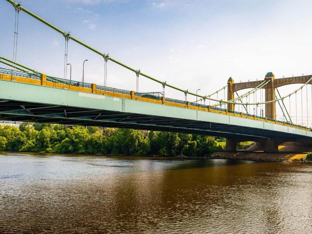 People walking along the Mississippi River riverfront in New Orleans during the afternoon