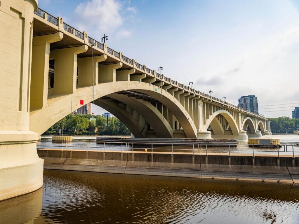 People walking along the Mississippi River riverfront in New Orleans during the afternoon