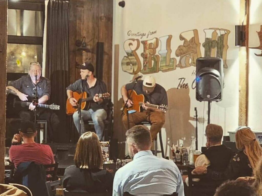 People enjoying dinner with live music in the background in Nashville