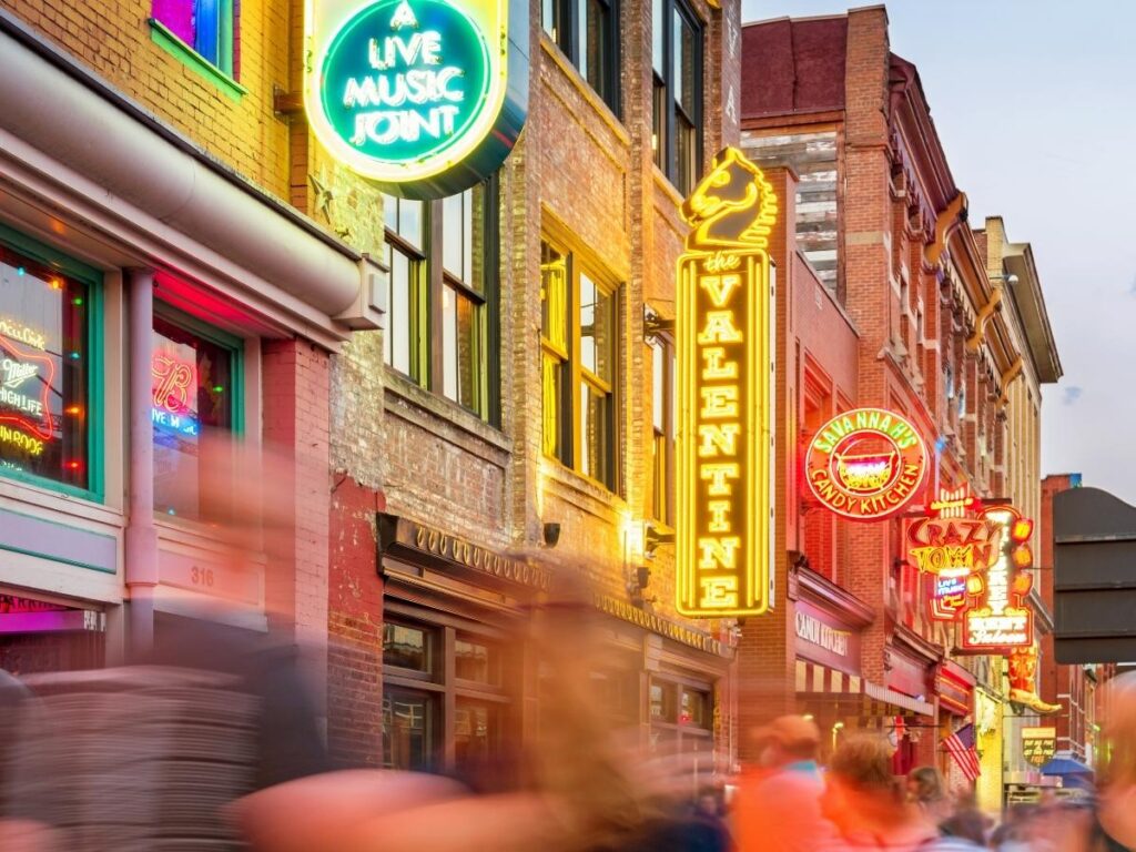 People walking past restaurants and patios in Nashville on a mild spring day