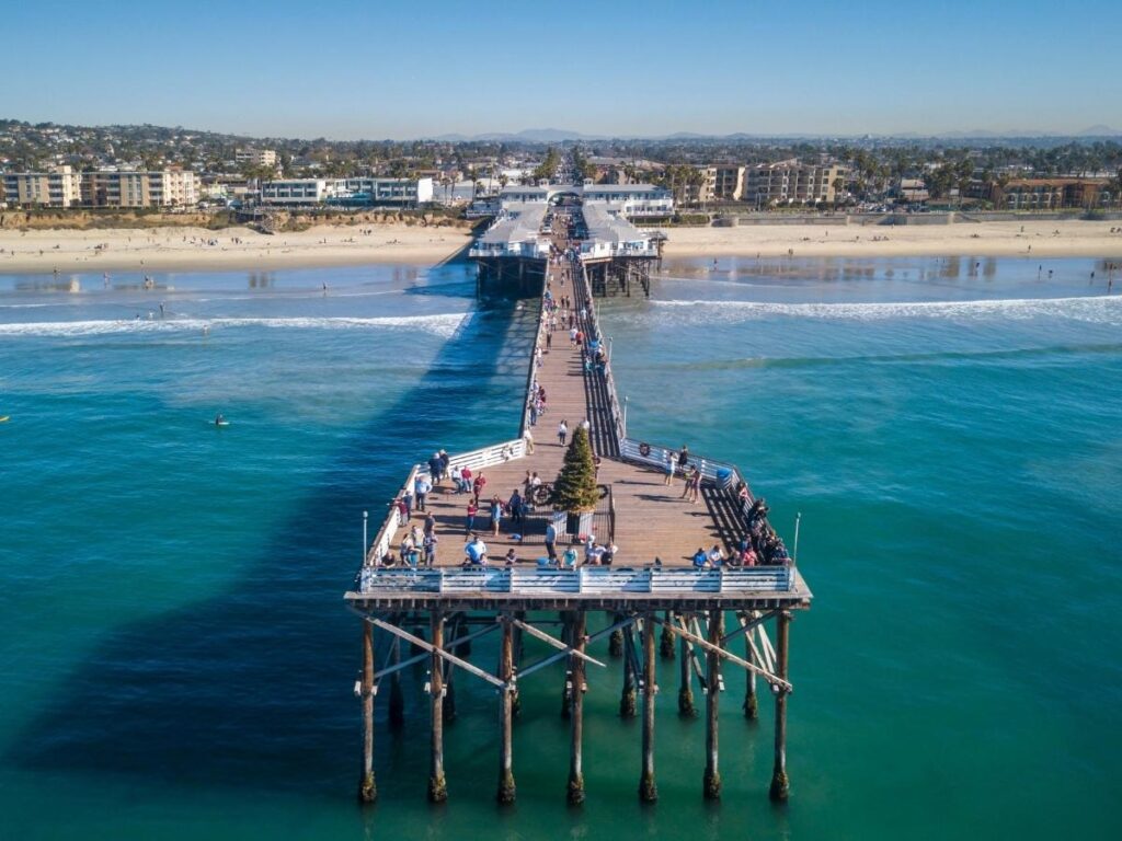 Wooden pier stretching into the ocean at Pacific Beach in San Diego.