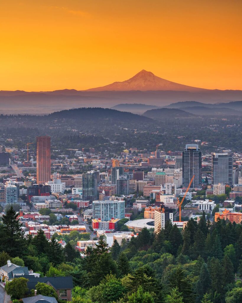 Sunset cityscape view from Pittock Mansion overlooking downtown Portland and Mt. Hood