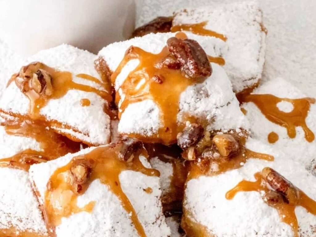 Close-up of powdered sugar-covered beignets on a plate in New Orleans