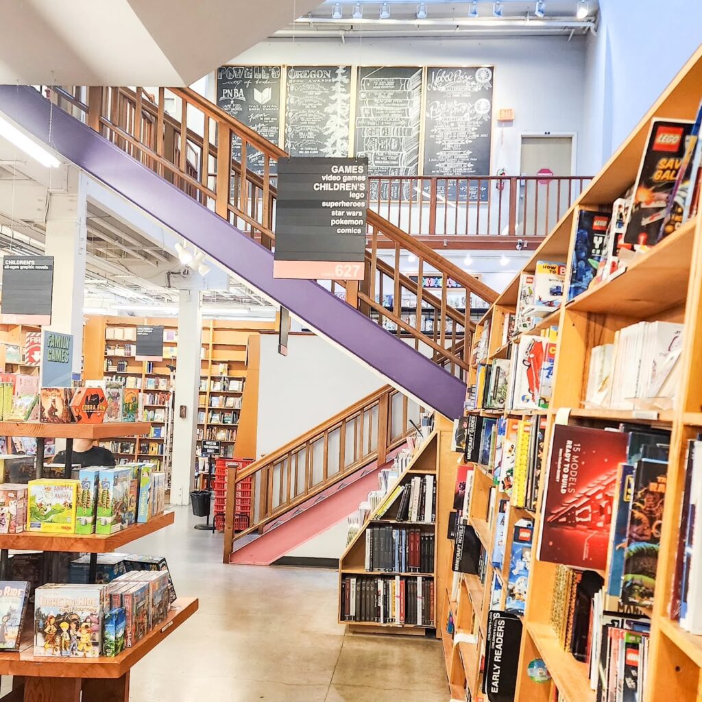 Interior view of Powell’s City of Books in Portland, showing colorful book stacks and cozy aisles