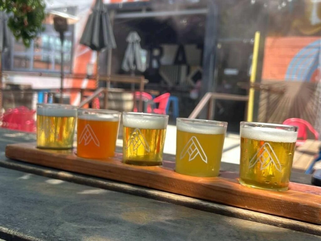 Outdoor patio seating and beer flight at Ratio Beerworks in Denver