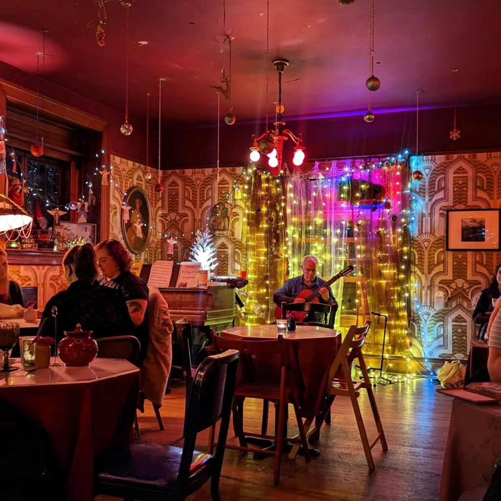 Cozy, eclectic interior of Rimsky-Korsakoffee House with candle-lit tables and classical decor