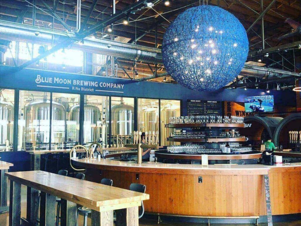 Outdoor patio seating at a brewery in RiNo Denver on a sunny afternoon.