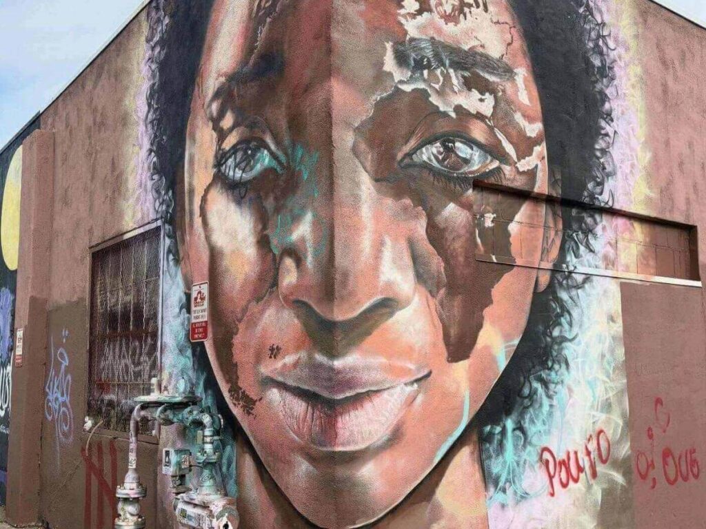 Large colorful mural on a warehouse wall in Denver’s RiNo district