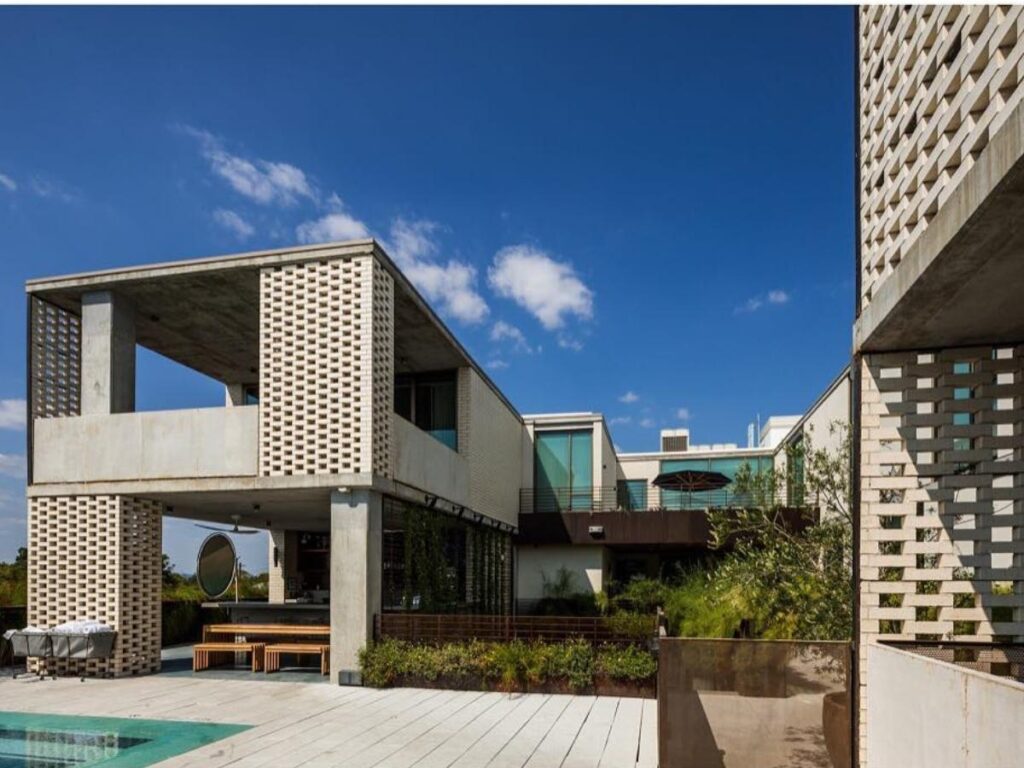 Small boutique hotel on South Congress with bright exterior and leafy patio