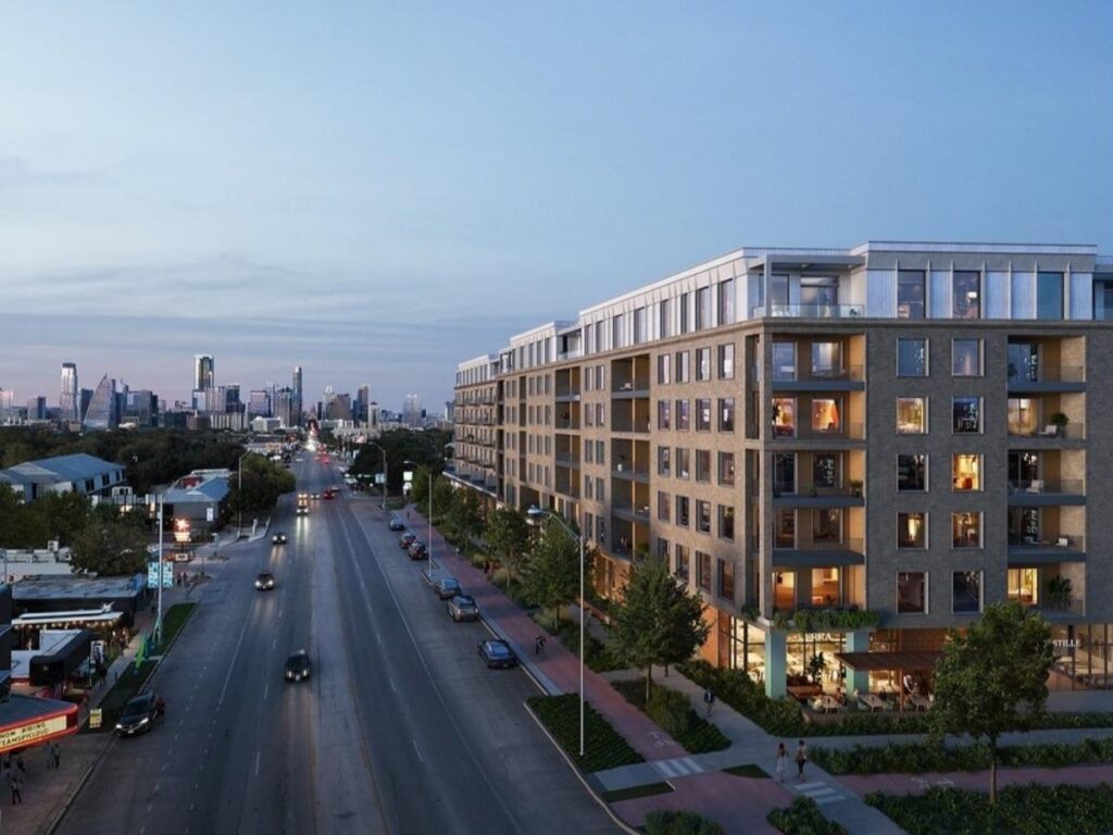 Early morning view of South Congress in Austin with colorful shops and the Capitol in the distance.