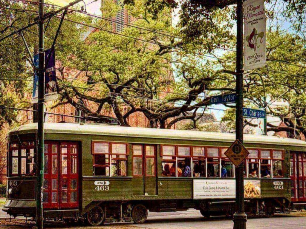A St. Charles streetcar passing through a shaded neighborhood in New Orleans