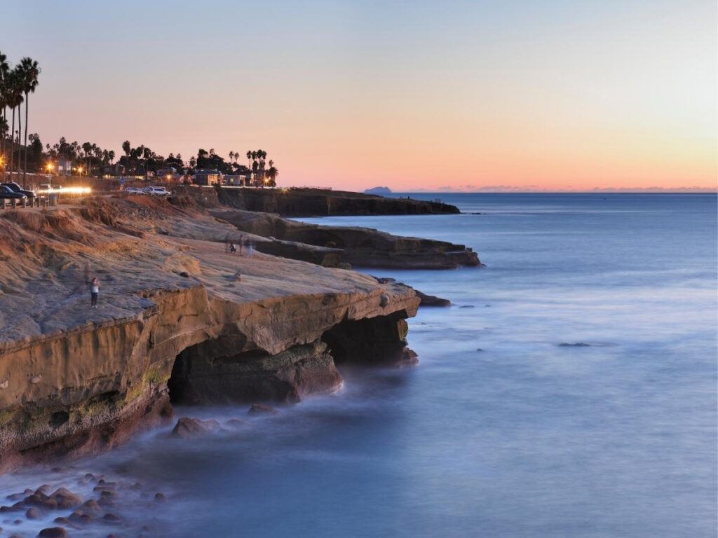 Sun setting over the ocean cliffs at Sunset Cliffs Natural Park in San Diego.