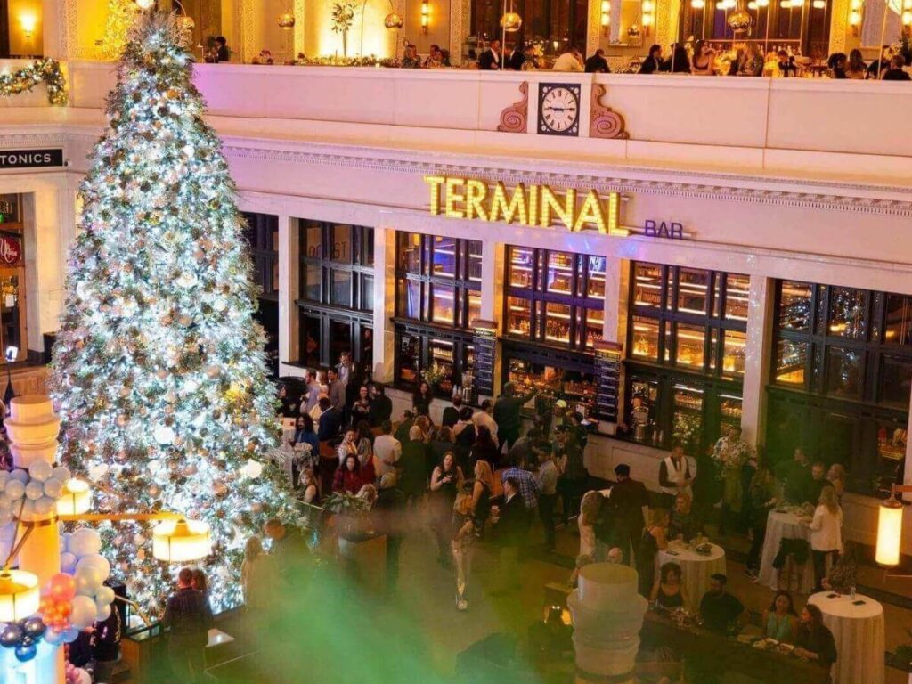 Morning light inside Denver Union Station with travelers and café seating