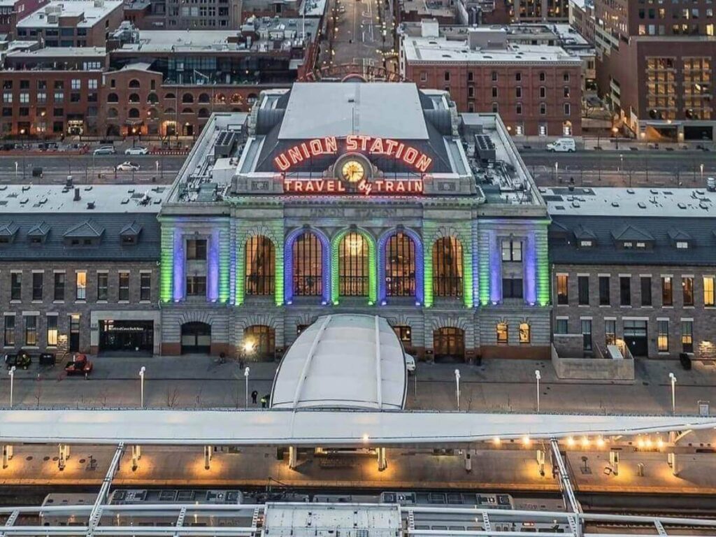 Exterior of Denver Union Station in LoDo with historic brick buildings nearby.