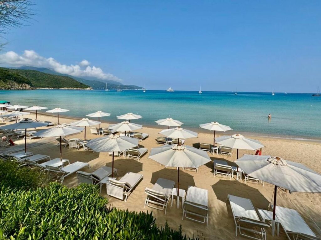 People on the sand and umbrellas at Ballard’s Beach bar.