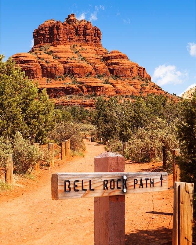 Hikers walking the Bell Rock Trail in Sedona, Arizona