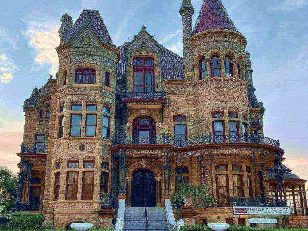 Historic limestone façade of Bishop’s Palace in Galveston with ornate details and bright morning light.