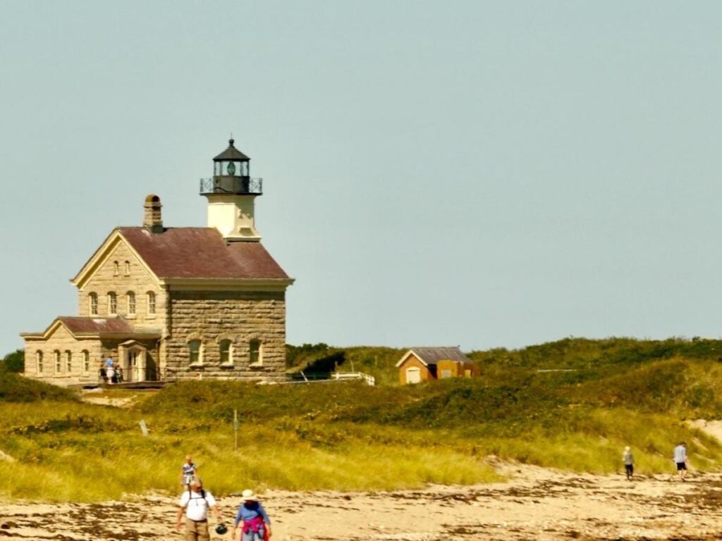North Light lighthouse on Block Island with rocky shoreline.