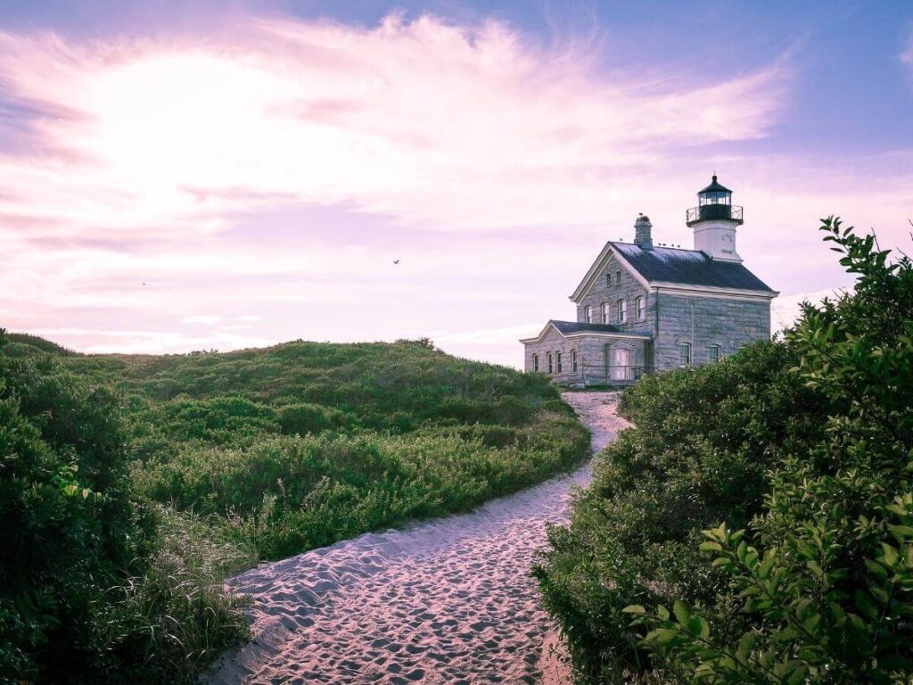 North Light lighthouse sitting on a rocky shoreline under an open sky.