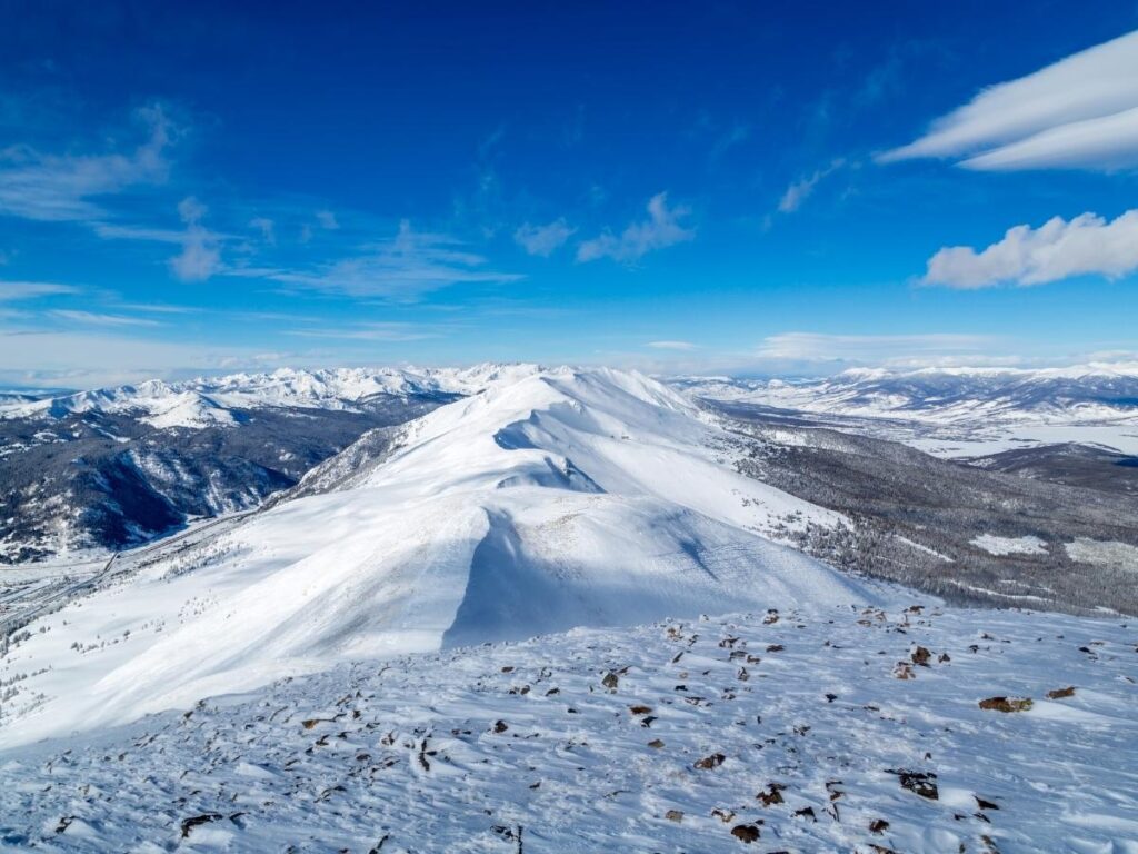 BreckConnect gondola ride with views over the trees toward Peak 8.