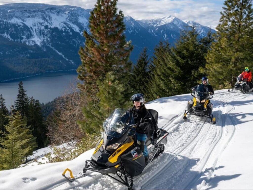 Snowmobile tour riding through snowy mountain trails near Breckenridge
