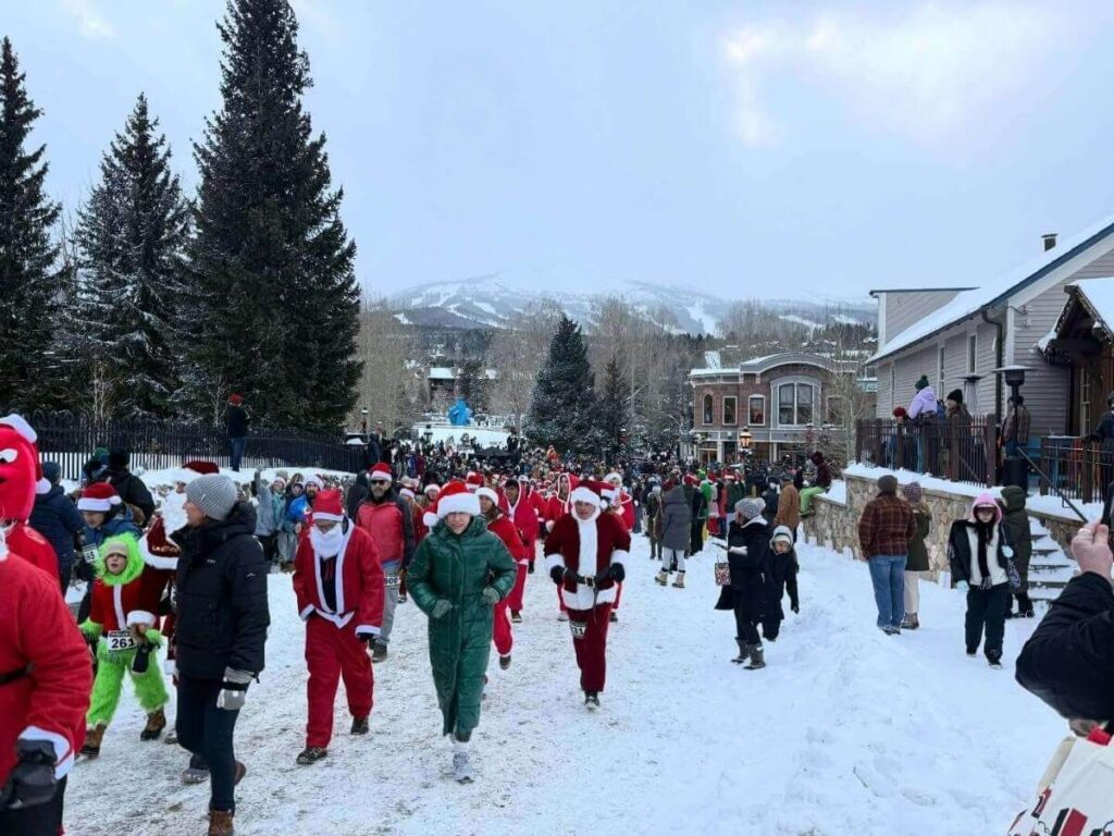 Snowy downtown Breckenridge with people walking along Main Street in winter,