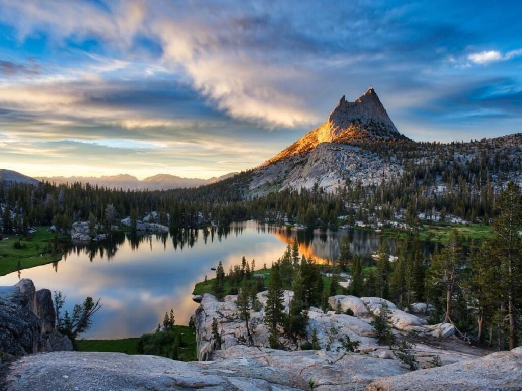 Cathedral Lake with deep blue water and jagged peaks rising behind under a clear sky