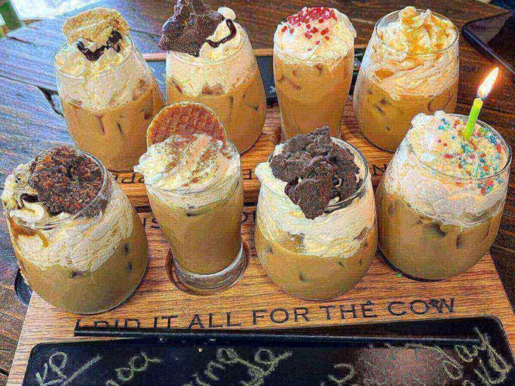 Coffee cup held near the shore of Lake Tahoe during a quiet morning