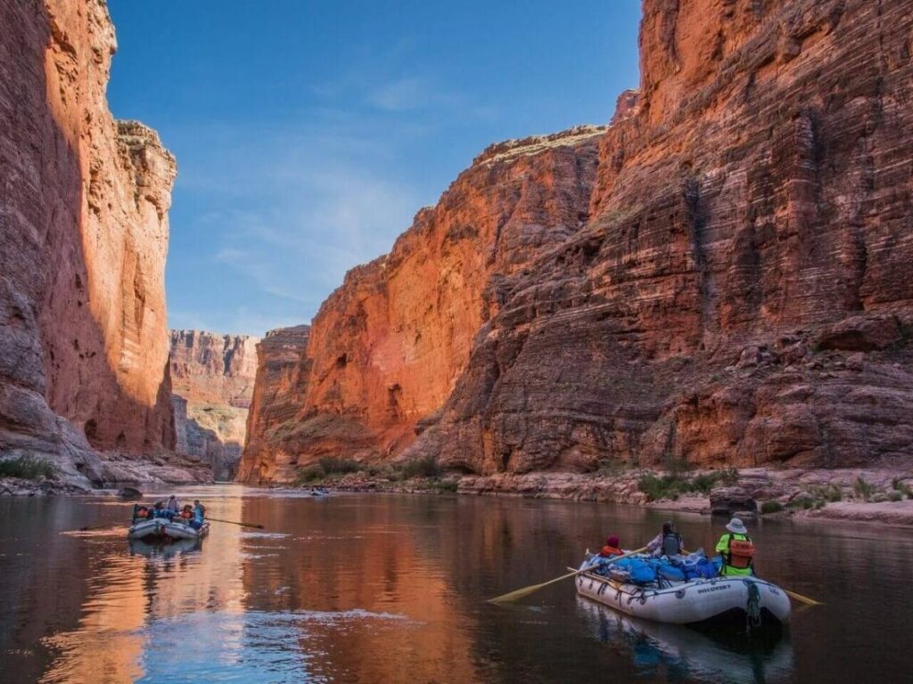 Rafting on the Colorado River surrounded by red rock canyon walls near Moab