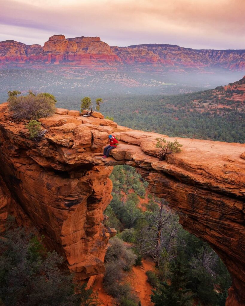 Hikers crossing Devil's Bridge, Sedona's famous natural sandstone arch