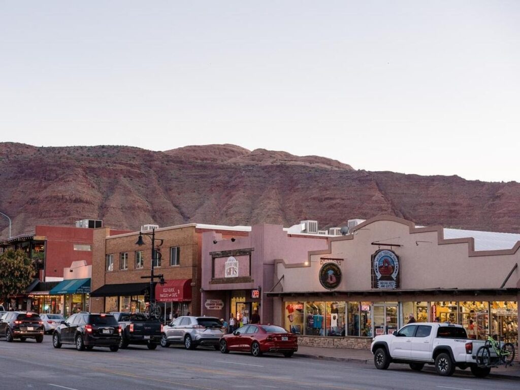 Main Street in downtown Moab with shops, bikes, and outdoor seating