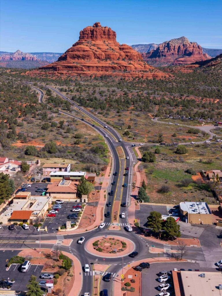 Scenic drive into Sedona with towering red rock formations along Highway 179