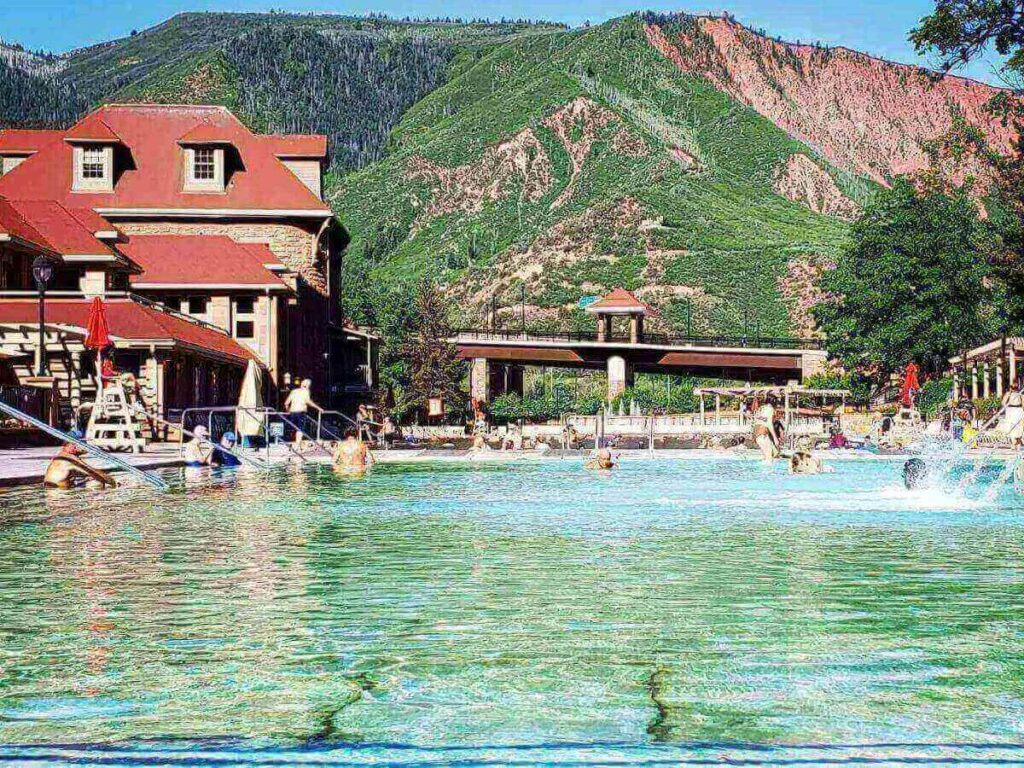 Glenwood Hot Springs pool with steam rising and canyon walls in the background