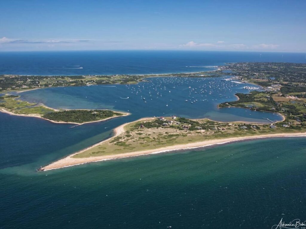 Sunset over Great Salt Pond with sailboats in the harbor.