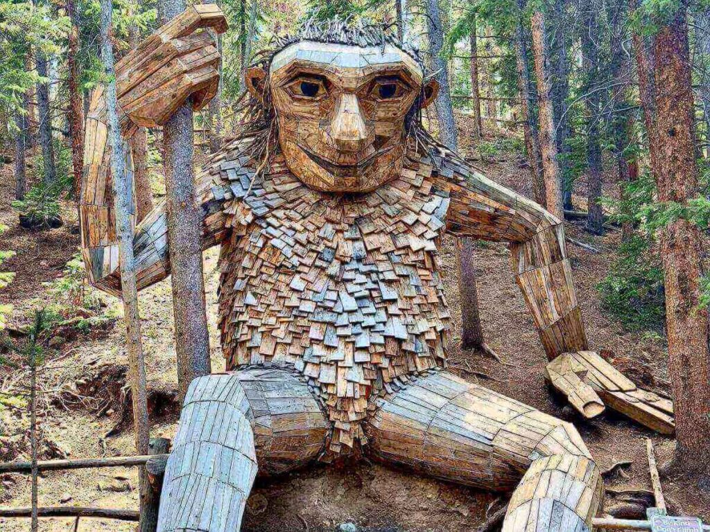 Isak Heartstone wooden troll sculpture along a forest trail in Breckenridge.