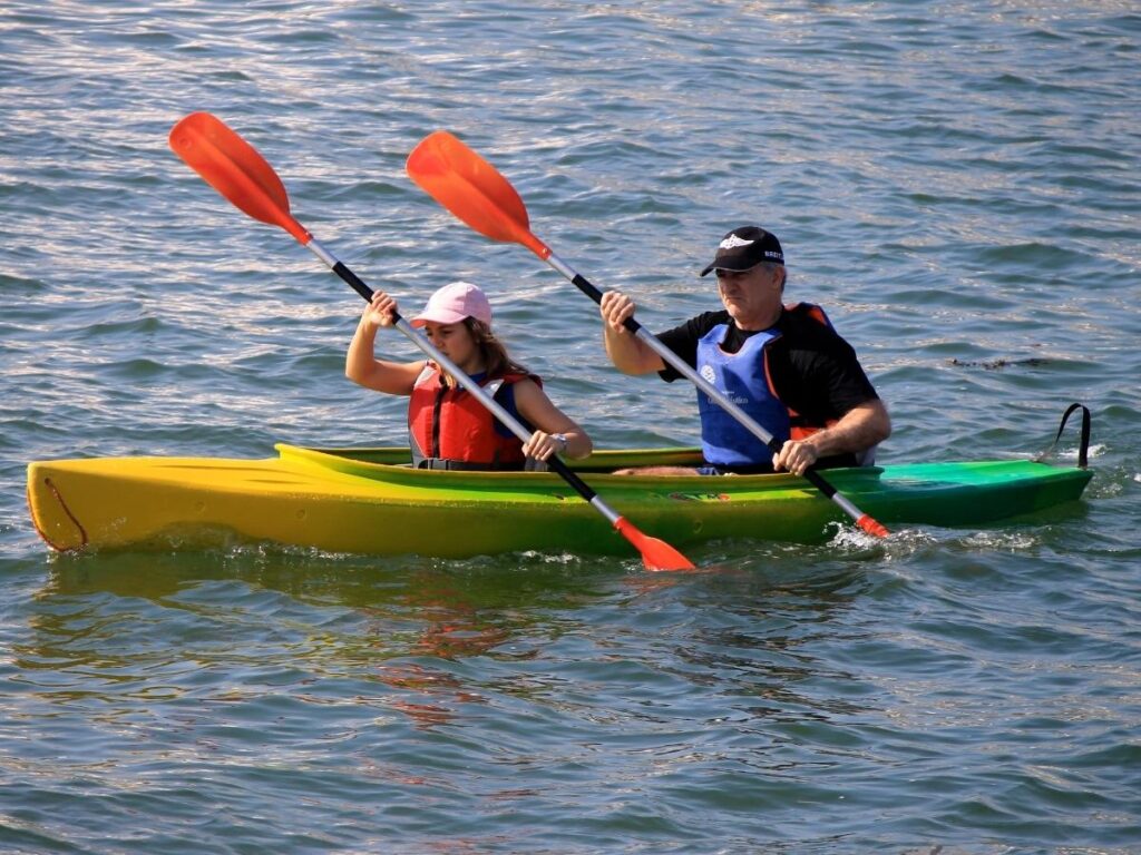 Kayaker paddling in the calm waters of Edgartown Harbor, Martha’s Vineyard.