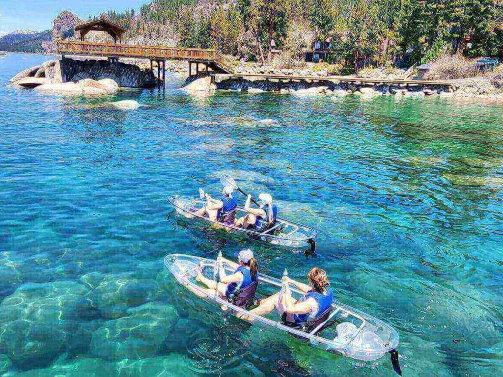 Kayaking along the calm shoreline of Lake Tahoe in the early morning