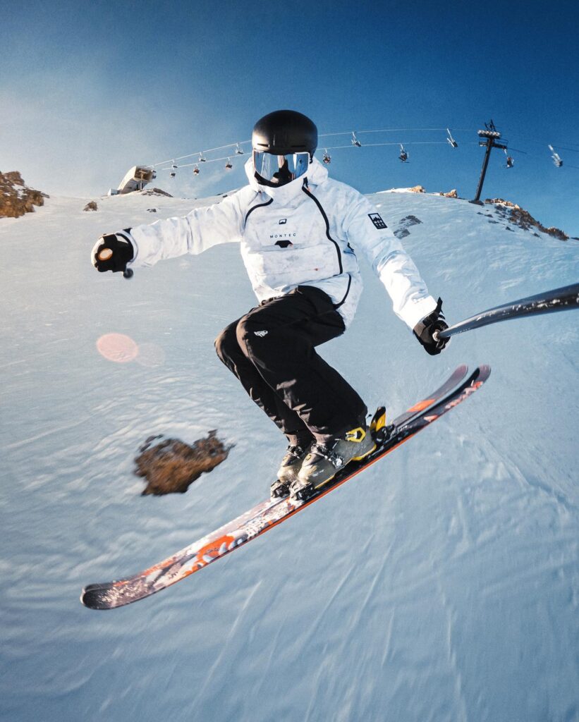 Skier on snowy slope with view of Eastern Sierra mountains