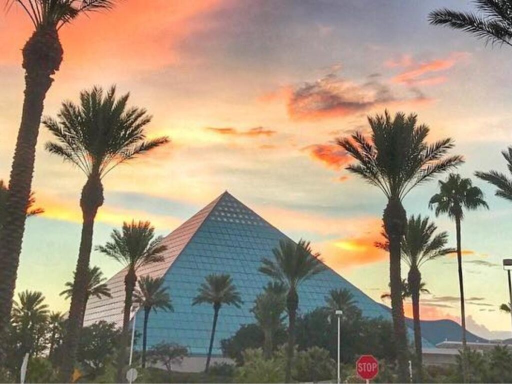 Blue glass exterior of the Moody Gardens Aquarium Pyramid on a bright sunny day