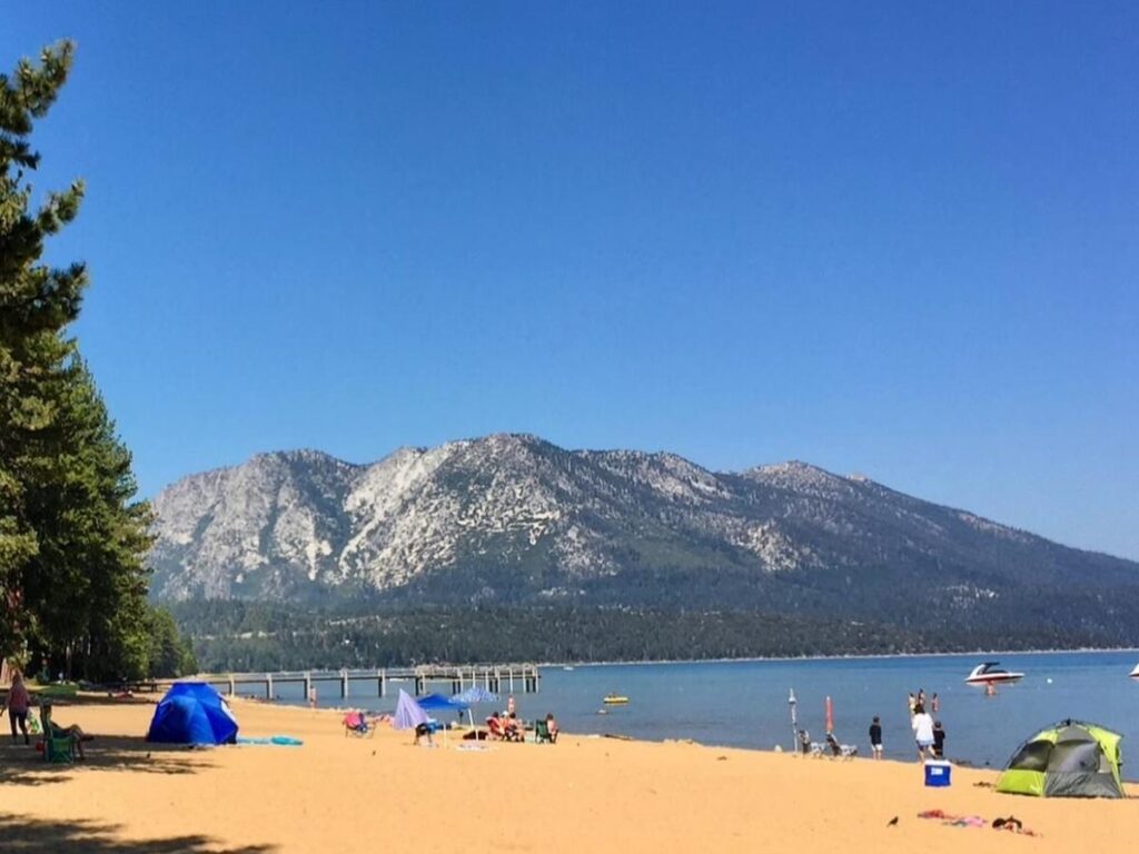 Quiet beach at Lake Tahoe in the early morning with calm water