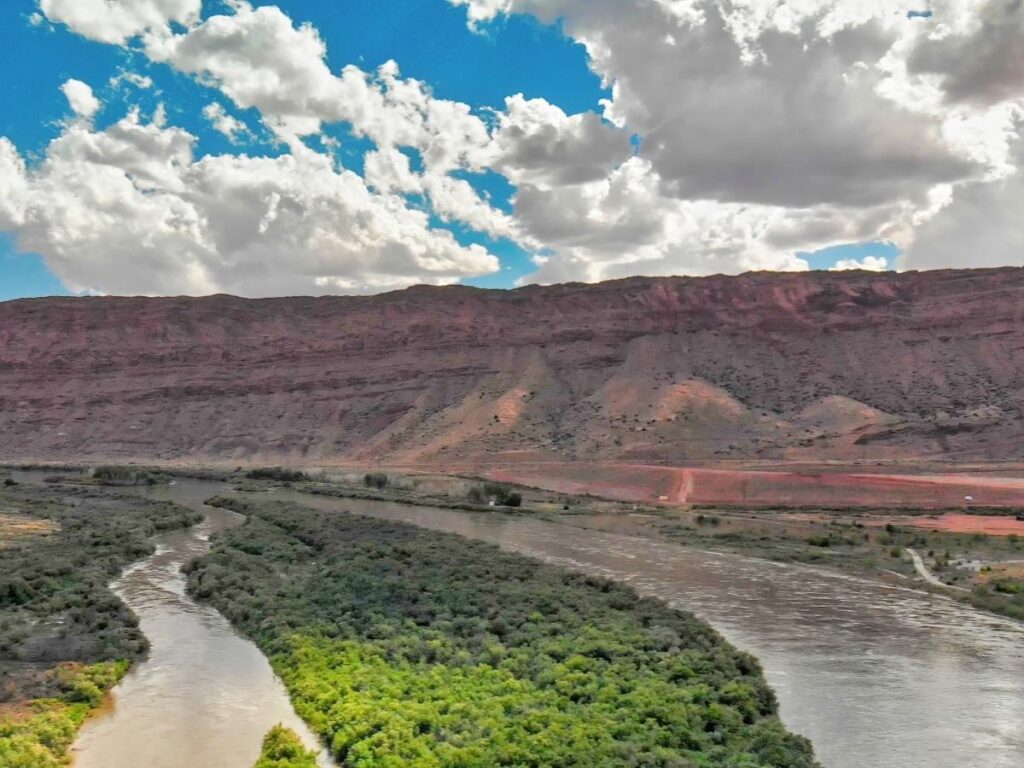 Scenic drive along the Colorado River near Moab with canyon walls on both sides